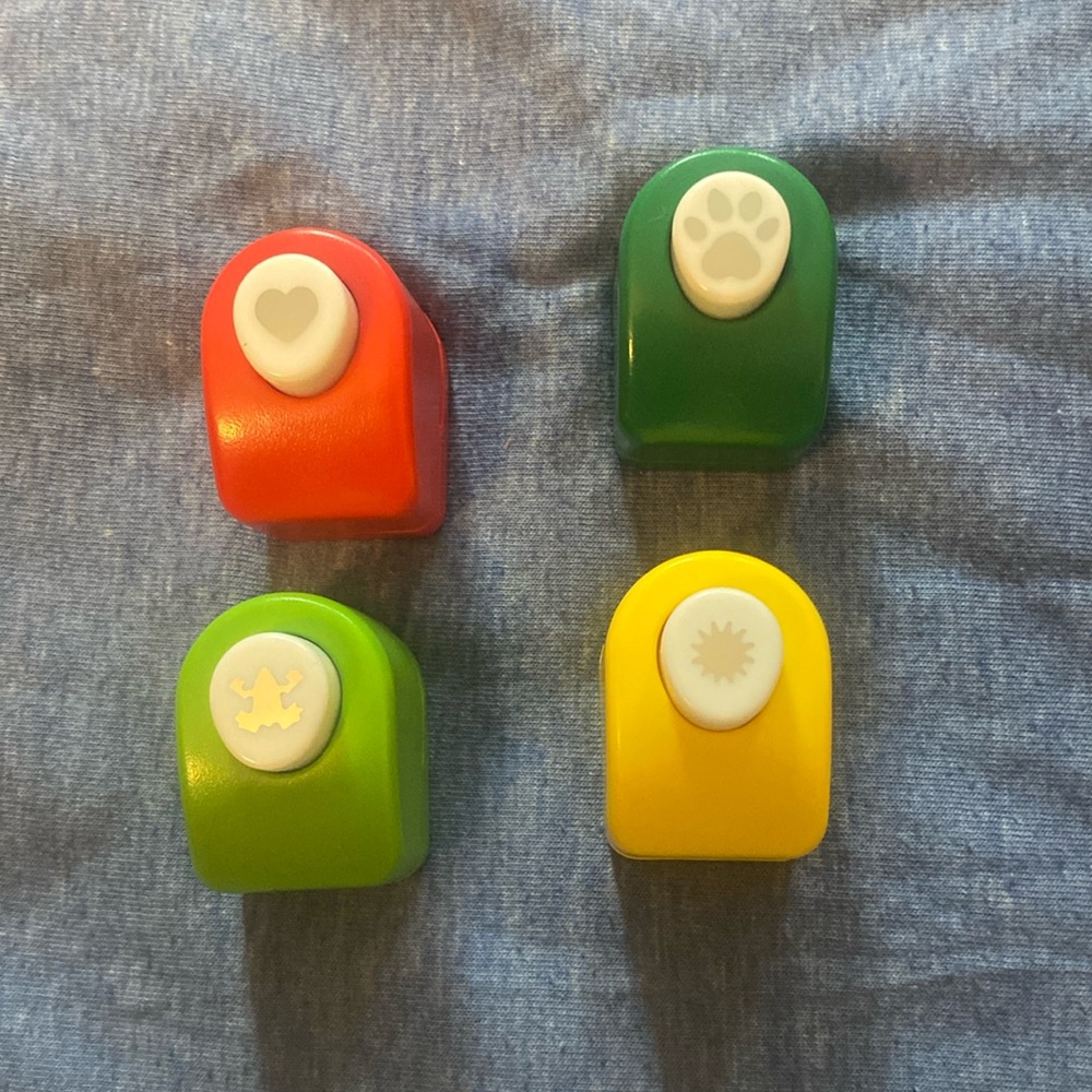 Bundle of 4 paper punches.  ( animal footprint, swirl, heart and frog)